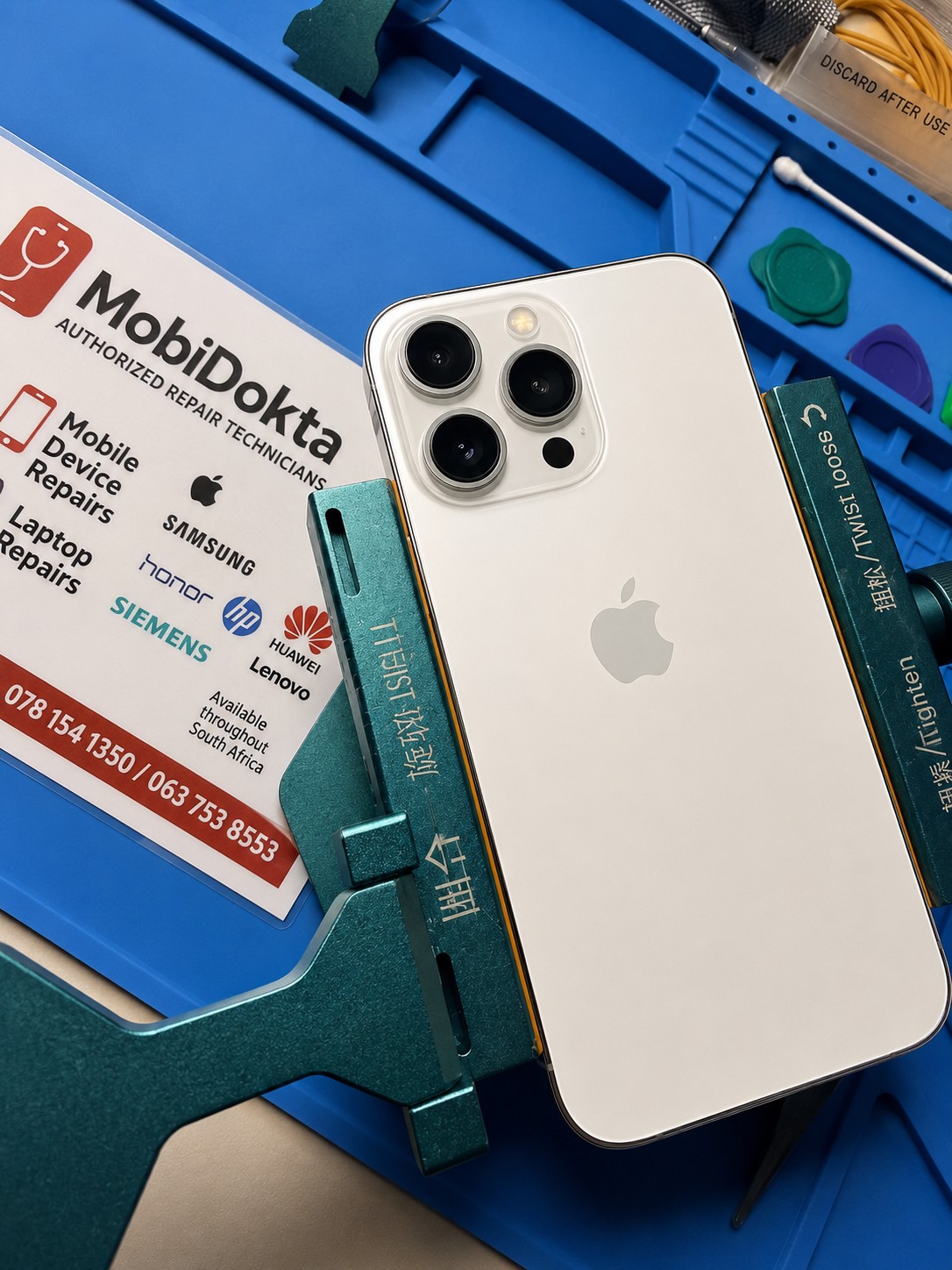 White iPhone 13 Pro on the MobiDokta bench after a back glass replacement