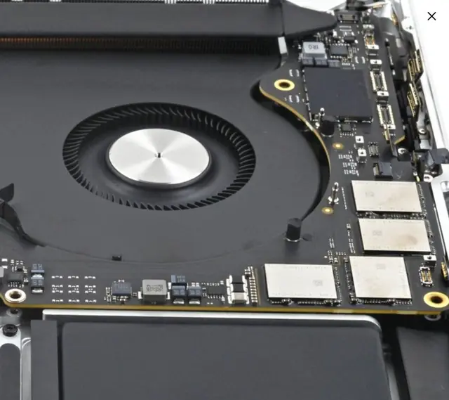 MacBook logic board and cooling fan opened for thermal service